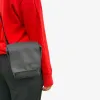 Woman wearing the black crossbody bag with a black strap – strap color can be customized.