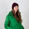 Portrait of a woman wearing a burgundy beanie made of 100% merino wool, made in Germany.